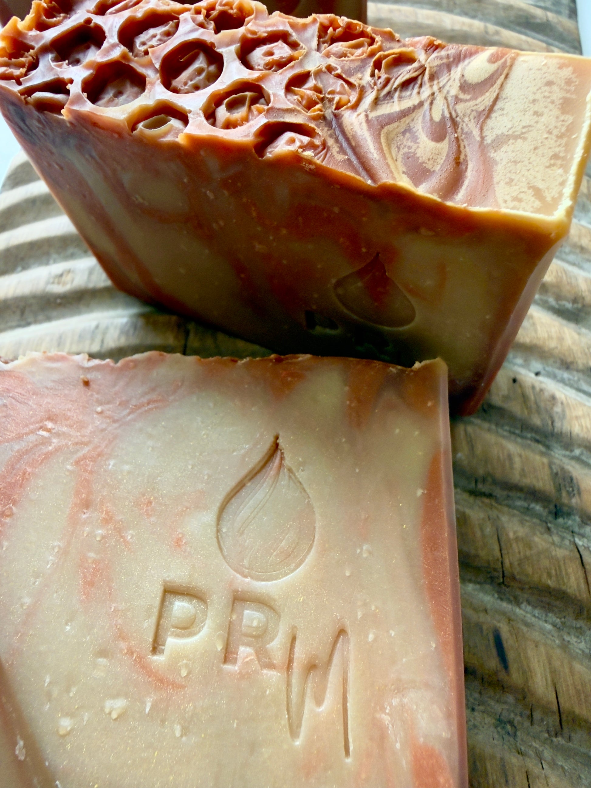 Apricot + Honey small batch soap bar with orange and cream swirl and PRM stamp.