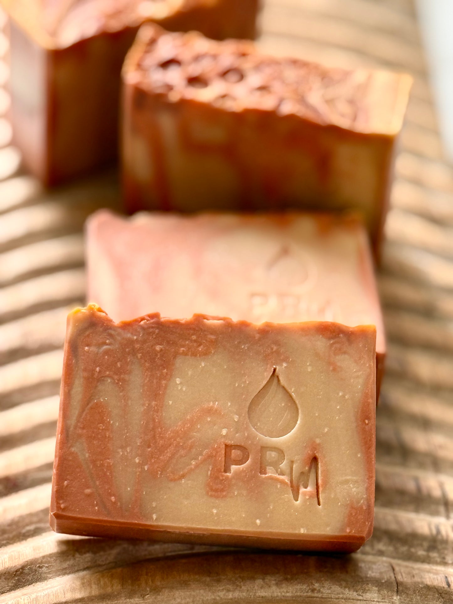 Hand-cut Apricot + Honey soap bars with textured tops and warm orange swirl.