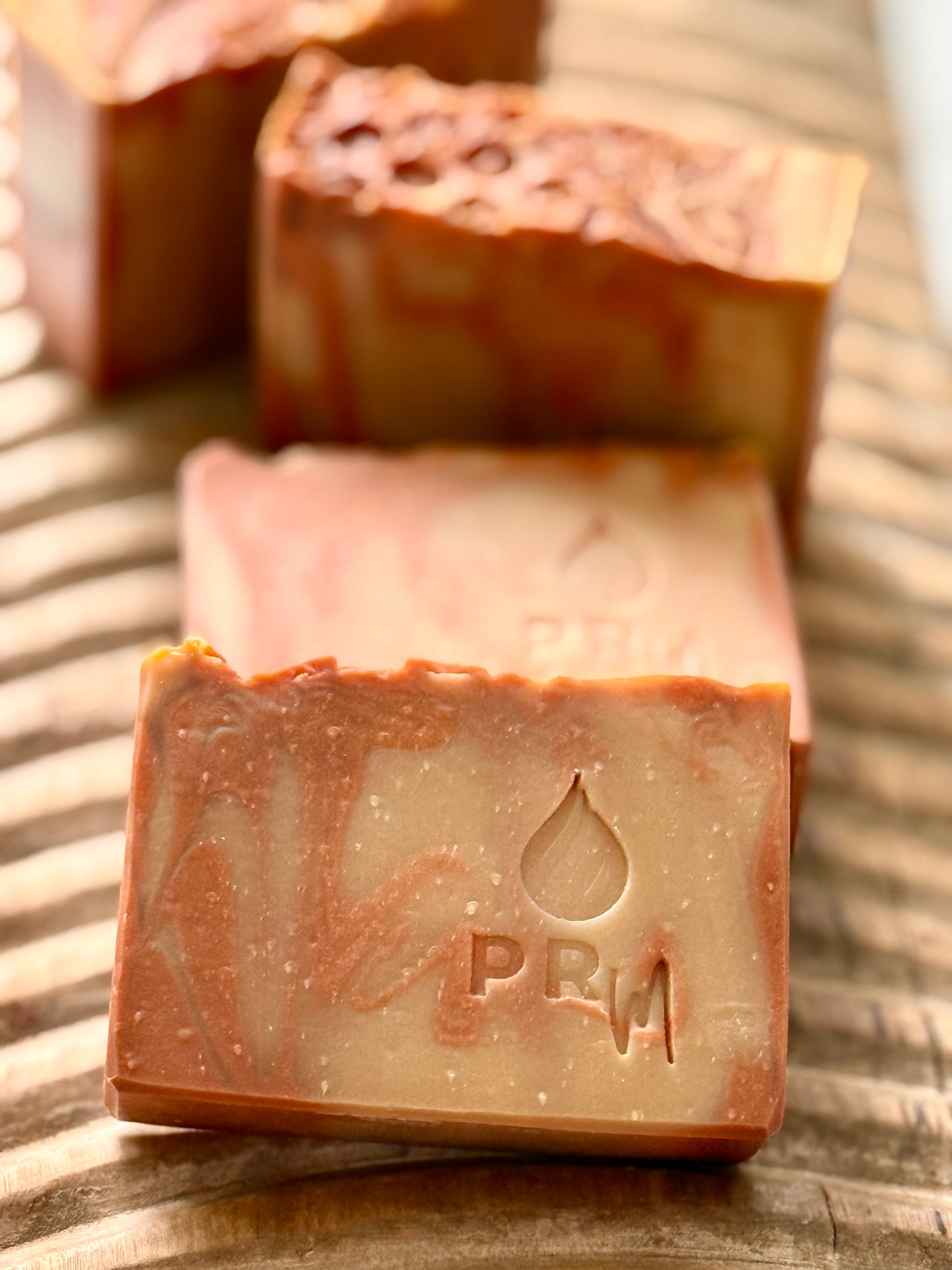Hand-cut Apricot + Honey soap bars with textured tops and warm orange swirl.