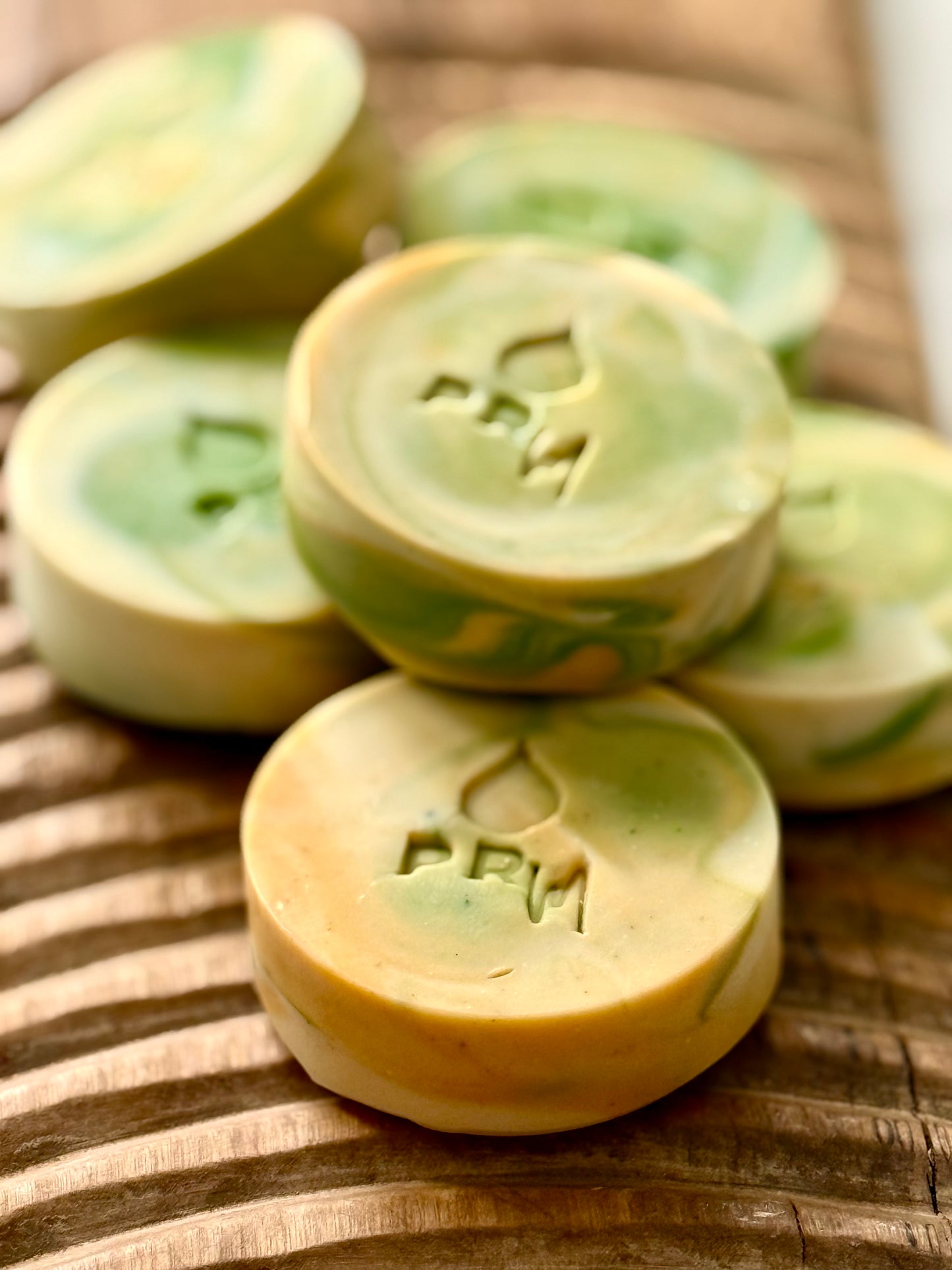 Small batch Lemon Basil Lavender milk soap bars with green, yellow, and cream swirl.