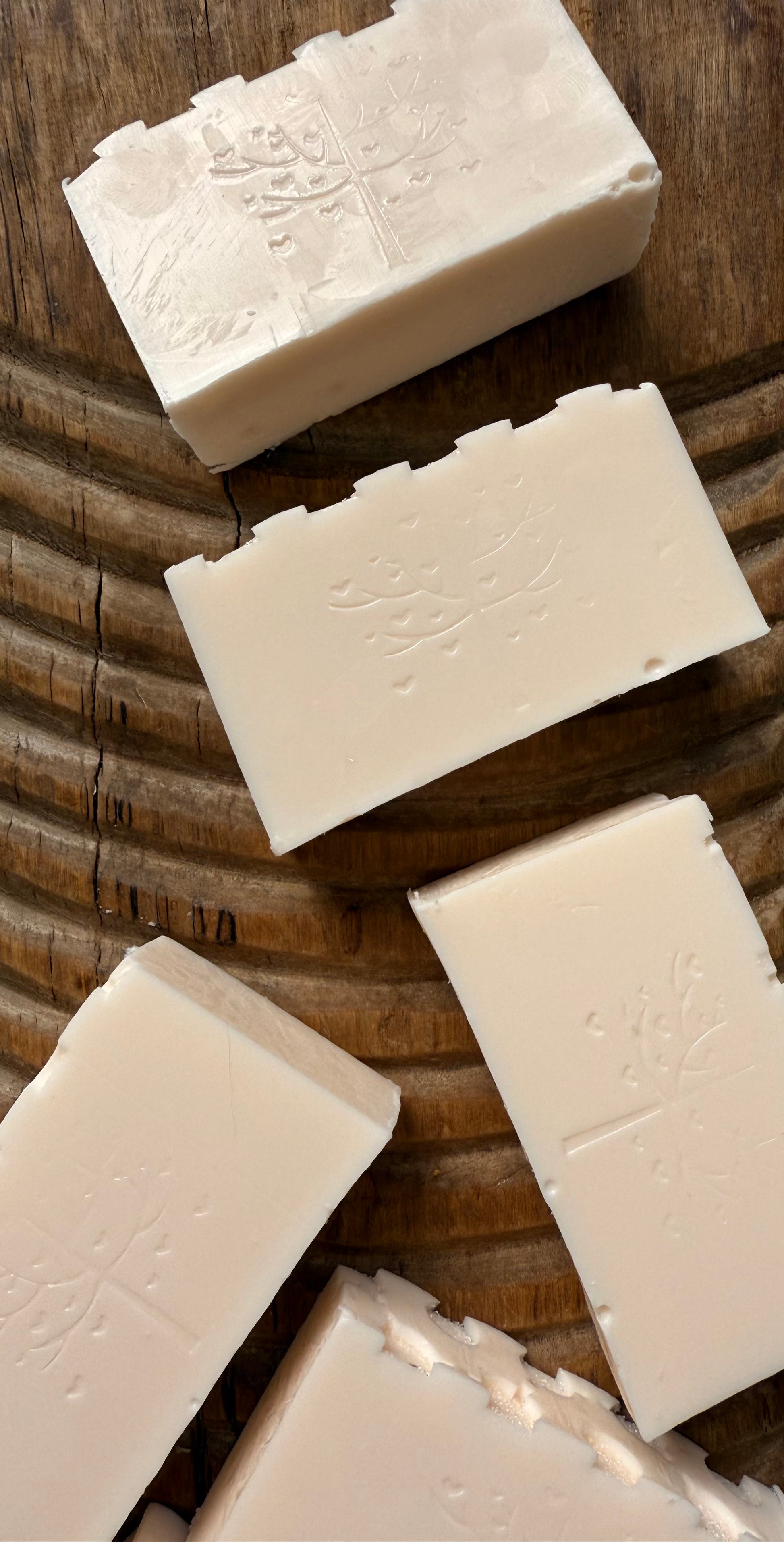 White soap bars on a wooden surface