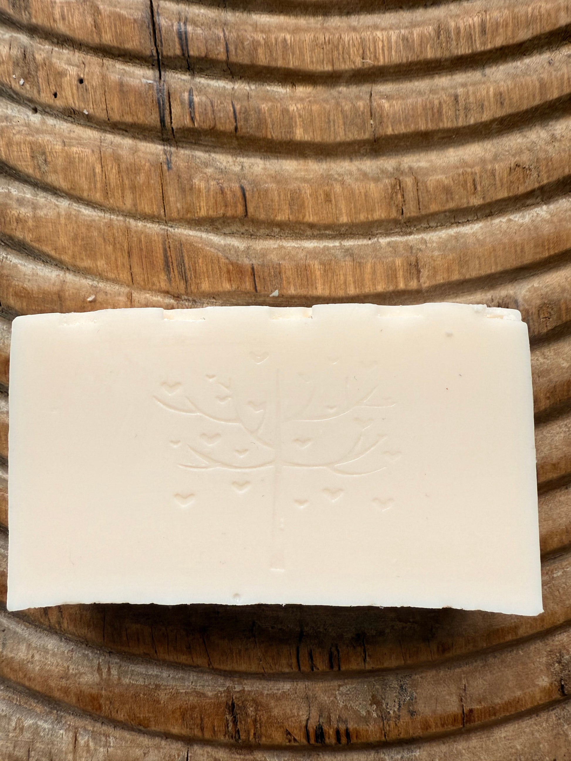 Rectangular bar of soap on a wooden surface